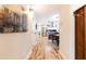 Hallway featuring hardwood floors, a view into the kitchen, and decorative wall art on the left at 955 Coleman Sw St, Atlanta, GA 30310
