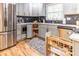 Bright kitchen featuring stainless steel appliances, light gray cabinets with gold hardware, and black and white backsplash at 955 Coleman Sw St, Atlanta, GA 30310