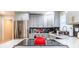 Bright kitchen featuring stainless steel appliances, updated cabinets, black and white backsplash, and quartz countertops at 955 Coleman Sw St, Atlanta, GA 30310