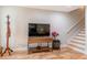 Living area featuring hardwood floors, console table, wall-mounted television, and decorative accessories at 955 Coleman Sw St, Atlanta, GA 30310