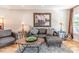 Cozy living room features a comfortable sofa, accent chairs, and a decorative rug on hardwood floors at 955 Coleman Sw St, Atlanta, GA 30310