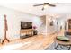 Well-lit living room with hardwood floors, a large TV, and easy access to other areas of the home at 955 Coleman Sw St, Atlanta, GA 30310