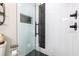 Modern shower with black and white tile, glass door, and matte black fixtures at 955 Coleman Sw St, Atlanta, GA 30310