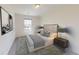Bright bedroom with neutral decor, a comfortable bed, and ambient lighting from lamps on bedside tables at 175 Silverton Dr, Dacula, GA 30019