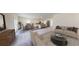 Spacious living room featuring modern furniture, an open floor plan, and seamless access to the kitchen and dining area at 175 Silverton Dr, Dacula, GA 30019