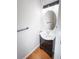 Small bathroom featuring a vanity with dark wood cabinets, a sink, and a large mirror at 2263 Leicester Se Way, Atlanta, GA 30316