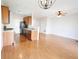 Open-concept kitchen and living area with wood cabinets, black appliances, and hardwood floors at 2263 Leicester Se Way, Atlanta, GA 30316