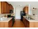 Well-lit kitchen with wooden cabinets, black appliances, and tile backsplash at 2263 Leicester Se Way, Atlanta, GA 30316