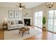 Bright living room featuring a fireplace, ceiling fan, and sliding glass doors leading to the outdoors at 2263 Leicester Se Way, Atlanta, GA 30316
