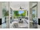 Cozy back porch with an outdoor seating area, fireplace, and serene views of the surrounding greenery at 331 Peachtree Ne Ave, Atlanta, GA 30305