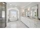 Luxurious bathroom with a soaking tub, marble countertops, and a glass-enclosed shower at 331 Peachtree Ne Ave, Atlanta, GA 30305