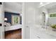 Bathroom with a marble vanity and a view into an adjacent bedroom with blue walls at 331 Peachtree Ne Ave, Atlanta, GA 30305