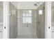Contemporary shower with glass door, gray tile, and stainless steel fixtures at 331 Peachtree Ne Ave, Atlanta, GA 30305
