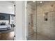 Modern bathroom shower with marble tile, a glass door, and shower seat at 331 Peachtree Ne Ave, Atlanta, GA 30305
