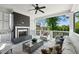 Relaxing covered porch with outdoor fireplace, ceiling fan, and plush seating at 331 Peachtree Ne Ave, Atlanta, GA 30305