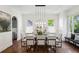Bright dining room featuring modern lighting, large windows, and seating for eight people at 331 Peachtree Ne Ave, Atlanta, GA 30305