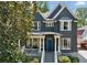 Two-story home with grey siding, white trim, covered porch, blue front door, and stone foundation at 331 Peachtree Ne Ave, Atlanta, GA 30305