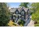 Two-story home with grey siding, white trim, covered porch, stone-lined driveway and swimming pool at 331 Peachtree Ne Ave, Atlanta, GA 30305