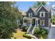 Two-story home with grey siding, white trim, covered porch, landscaped yard, and stone-lined driveway at 331 Peachtree Ne Ave, Atlanta, GA 30305