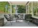 Covered front porch with seating and outdoor rug at 331 Peachtree Ne Ave, Atlanta, GA 30305