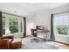 Bright home office with lots of natural light from the large windows and a comfortable leather chair at 331 Peachtree Ne Ave, Atlanta, GA 30305