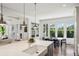 Open kitchen with stainless steel appliances, center island, and view into the light-filled dining area at 331 Peachtree Ne Ave, Atlanta, GA 30305