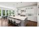 Open kitchen boasts white cabinetry, marble countertops, and a large center island with seating at 331 Peachtree Ne Ave, Atlanta, GA 30305
