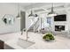 Kitchen island featuring white marble counters, stainless faucet and seating, with a view of the living room at 331 Peachtree Ne Ave, Atlanta, GA 30305
