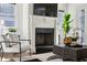 Fireplace detail in bright, comfortable living room with dark-framed windows and modern decor at 331 Peachtree Ne Ave, Atlanta, GA 30305