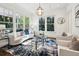 Sunlit living room with hardwood floors, large windows, white trim and seating at 331 Peachtree Ne Ave, Atlanta, GA 30305