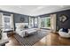 Spacious main bedroom with hardwood floors, elegant decor, and large windows that let in natural light at 331 Peachtree Ne Ave, Atlanta, GA 30305
