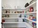 Spacious pantry with white shelves stocked with food items at 331 Peachtree Ne Ave, Atlanta, GA 30305