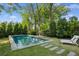 Backyard pool surrounded by lush greenery, with lounge chairs at 331 Peachtree Ne Ave, Atlanta, GA 30305