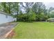 Side yard with a patio and a lush green lawn at 8051 Trinity Park Dr, Riverdale, GA 30296