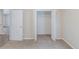 Bedroom featuring a closet with bi-fold doors, neutral walls, and carpet at 8051 Trinity Park Dr, Riverdale, GA 30296