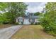 Charming single-story home featuring a well-maintained front yard and classic curb appeal with red shutters at 8051 Trinity Park Dr, Riverdale, GA 30296