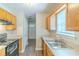 Classic kitchen with wood cabinets, stainless steel sink and modern appliances at 8051 Trinity Park Dr, Riverdale, GA 30296