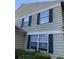 Exterior view of home, showcasing windows, and dark shutters amidst well-maintained landscaping at 1304 Old Coach Sw Rd, Marietta, GA 30008