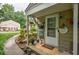 Inviting front door with landscaping, walkway, and charming decor in a well-maintained community at 1304 Old Coach Sw Rd, Marietta, GA 30008
