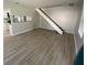 Open-concept living room with wood floors, staircase, and views of the kitchen for modern living at 1304 Old Coach Sw Rd, Marietta, GA 30008