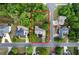 An aerial shot showcases a verdant property with mature trees, a charming home, and a well-kept lawn in a serene neighborhood at 31 Clearview Dr, Cartersville, GA 30121