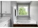 Bathroom featuring a relaxing white soaking tub with a large window view at 31 Clearview Dr, Cartersville, GA 30121