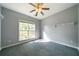 Bedroom with neutral walls and carpeting, a ceiling fan, and a window view at 31 Clearview Dr, Cartersville, GA 30121