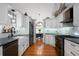 Spacious eat-in kitchen with white cabinets, hardwood floors and stainless steel appliances at 31 Clearview Dr, Cartersville, GA 30121