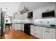 Bright kitchen featuring white cabinetry, modern appliances, and hardwood flooring at 31 Clearview Dr, Cartersville, GA 30121