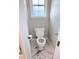 Powder room featuring new fixtures, toilet, and marbling floors at 515 Sherwin Ct, Mcdonough, GA 30252