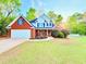 Lovely brick home featuring a manicured lawn, white garage door, and a welcoming front porch at 515 Sherwin Ct, Mcdonough, GA 30252