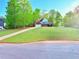 View of house, green lawn, and surrounding trees, showing the property's spacious front yard at 515 Sherwin Ct, Mcdonough, GA 30252