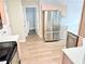 Modern kitchen with stainless steel appliances and light wood cabinets, with laundry in the background at 515 Sherwin Ct, Mcdonough, GA 30252