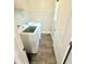 Clean and organized laundry room with a washing machine, dryer, and shelves for storage at 515 Sherwin Ct, Mcdonough, GA 30252